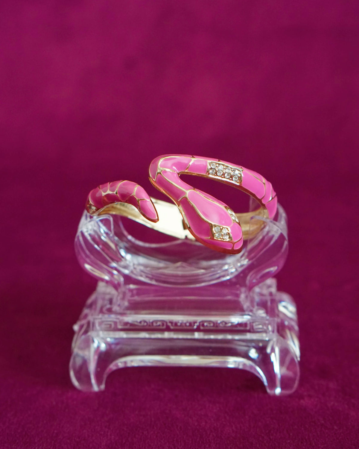 Hinged bangle shaped like a snake winding around the wrist, in orchid pink enamel scales