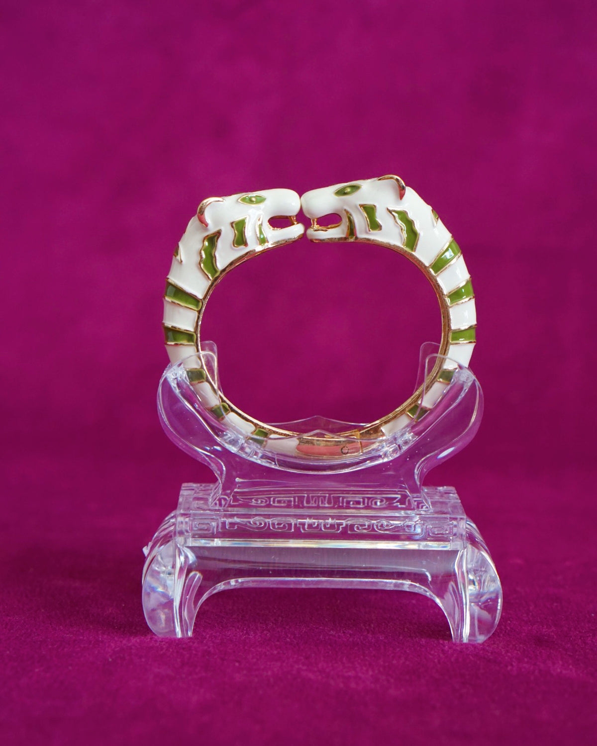 Hinged bangle with two cream tigers meeting face to face, striped in olive green
