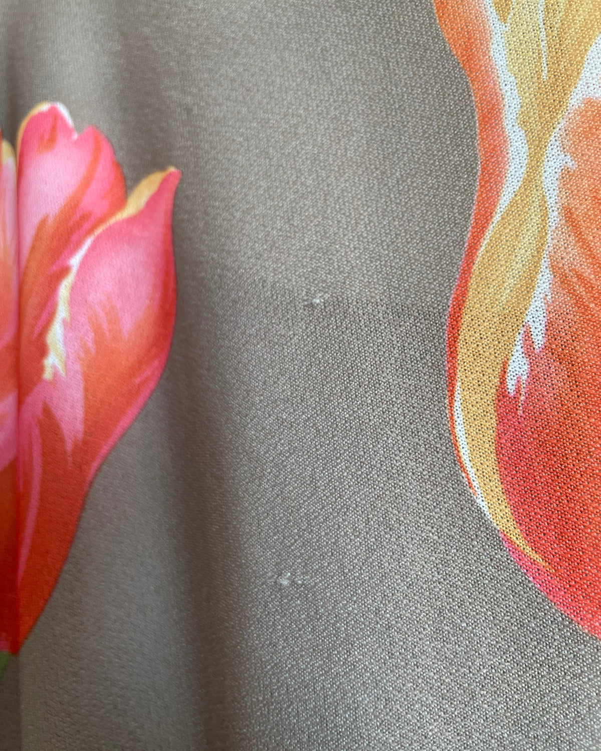 A vintage Herman Marcus tulip print dress in a taupe and cream colorblock with dolman sleeves, shown against a kraft background