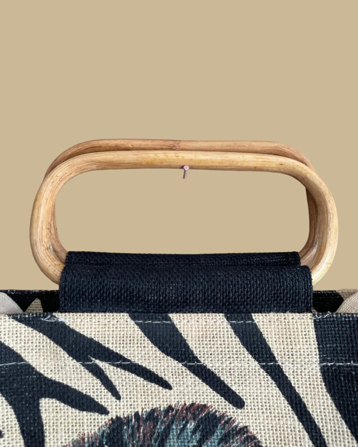 A vintage handmade zebra print canvas tote bag with bamboo handles and a fabric shoulder strap, shown against a kraft background