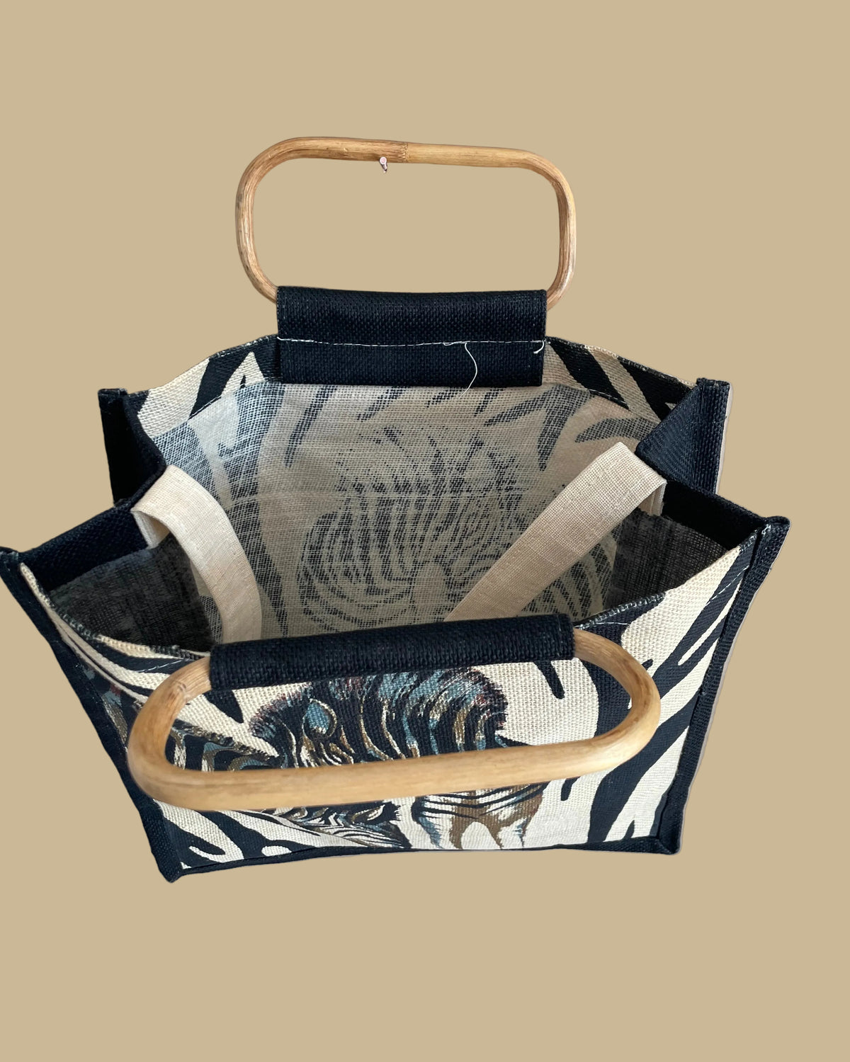 A vintage handmade zebra print canvas tote bag with bamboo handles and a fabric shoulder strap, shown against a kraft background