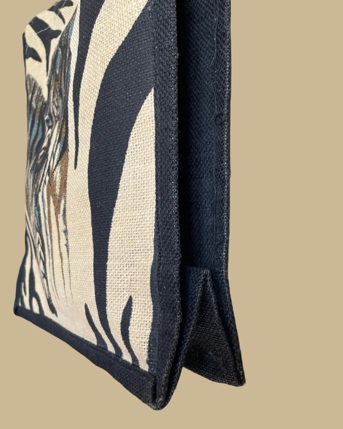 A vintage handmade zebra print canvas tote bag with bamboo handles and a fabric shoulder strap, shown against a kraft background