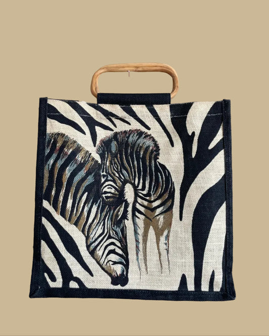 A vintage handmade zebra print canvas tote bag with bamboo handles and a fabric shoulder strap, shown against a kraft background