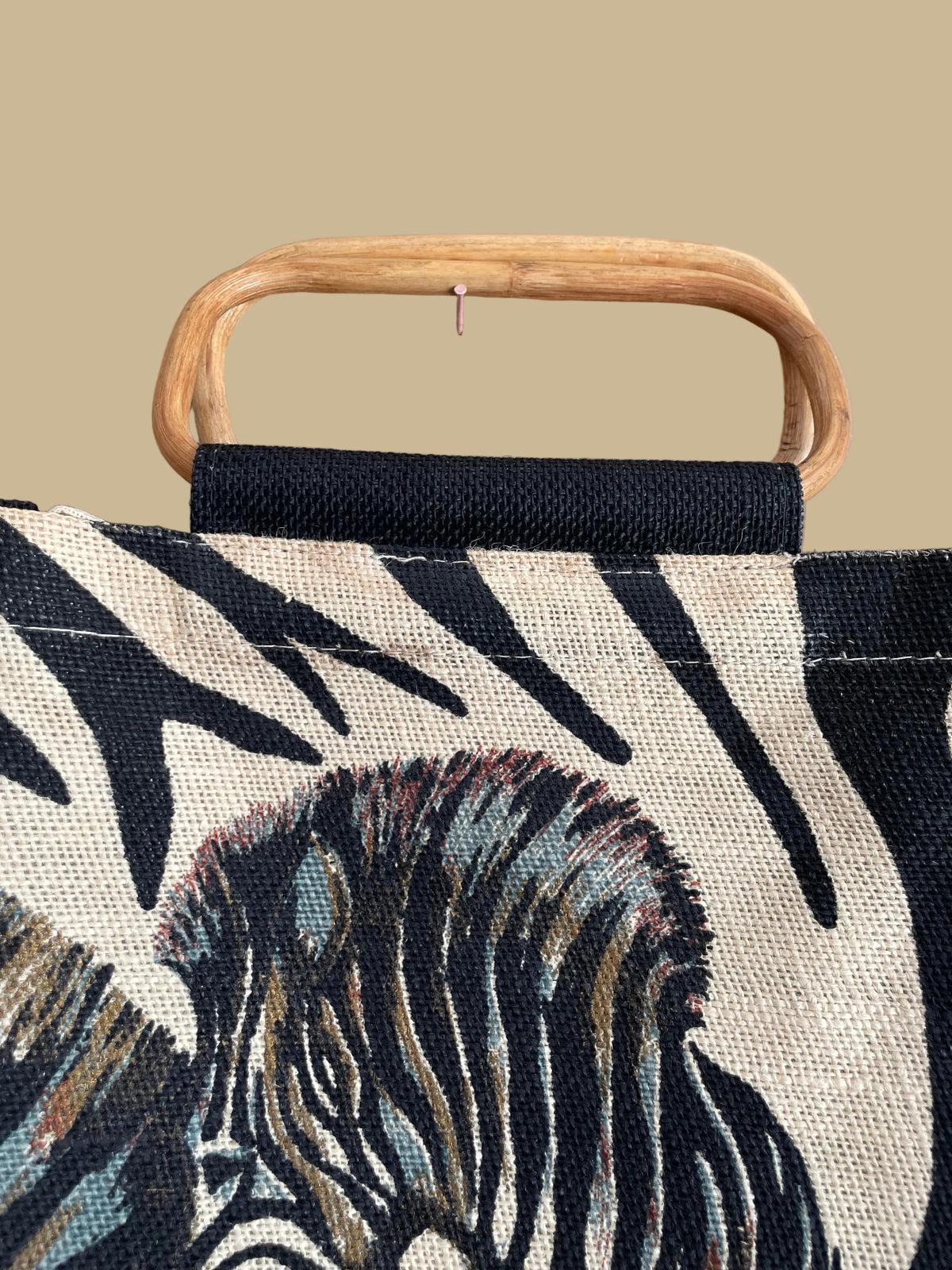 A vintage handmade zebra print canvas tote bag with bamboo handles and a fabric shoulder strap, shown against a kraft background